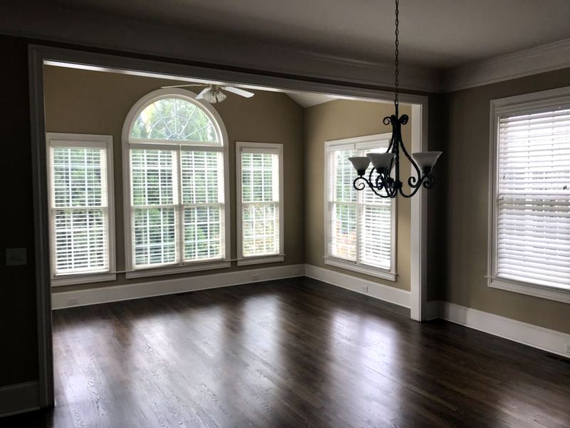 Dining room with an arched window and a dark stained oak floor