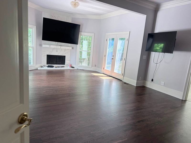 Family room with a marble fireplace and a dark stained oak floor
