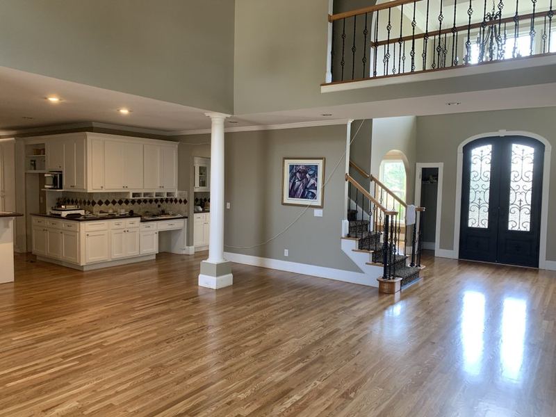 Two-story great room and foyer with a natural oak floor