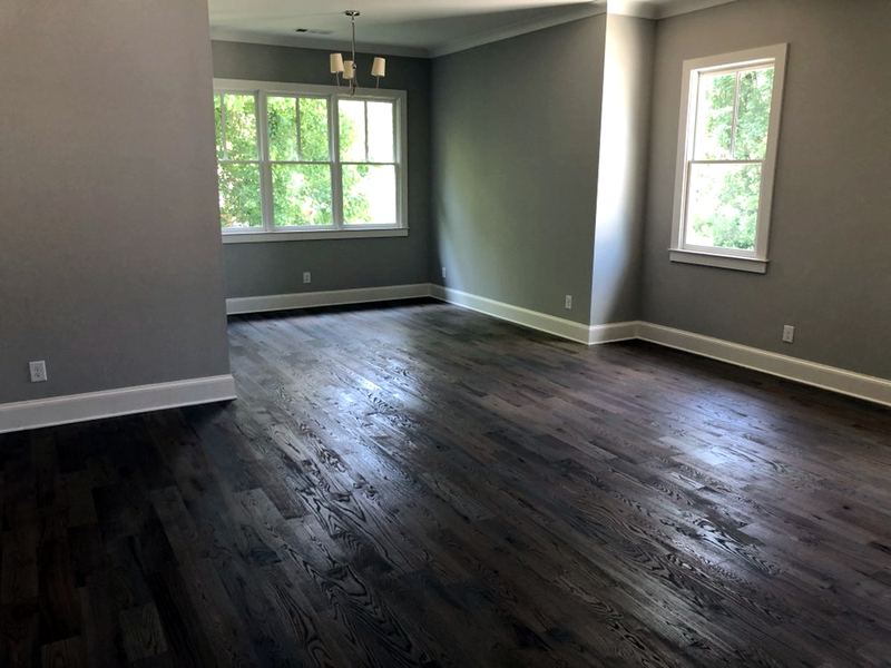 Empty room in a new home with a dark stained oak floor