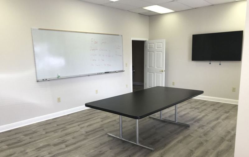 Office conference room with new gray plank flooring