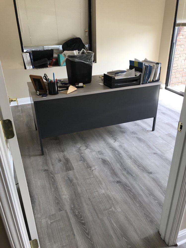 Private office with gray plank flooring