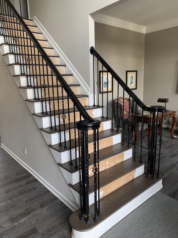 Staircase with stained treads and iron spindles before the risers were finished